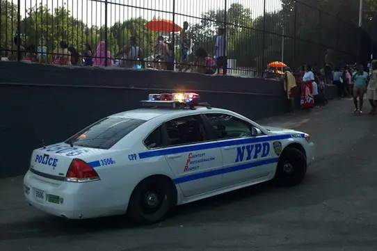 A police car in front of Lasker Pool in Harlem, courtesy Geoffrey Croft / NYC Park Advocates